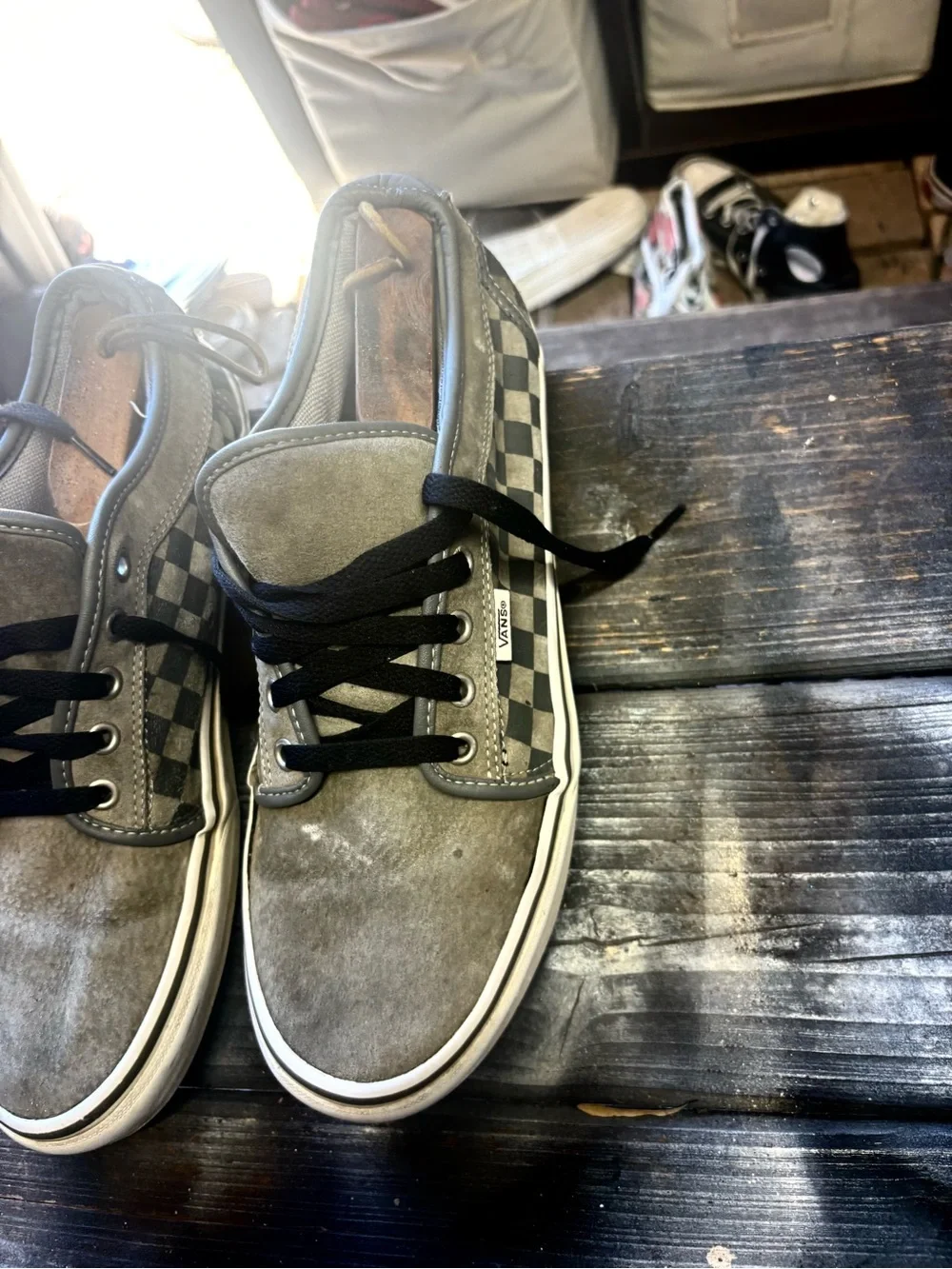 Vans gray suede sneakers with black & white checkerboard pattern on the side